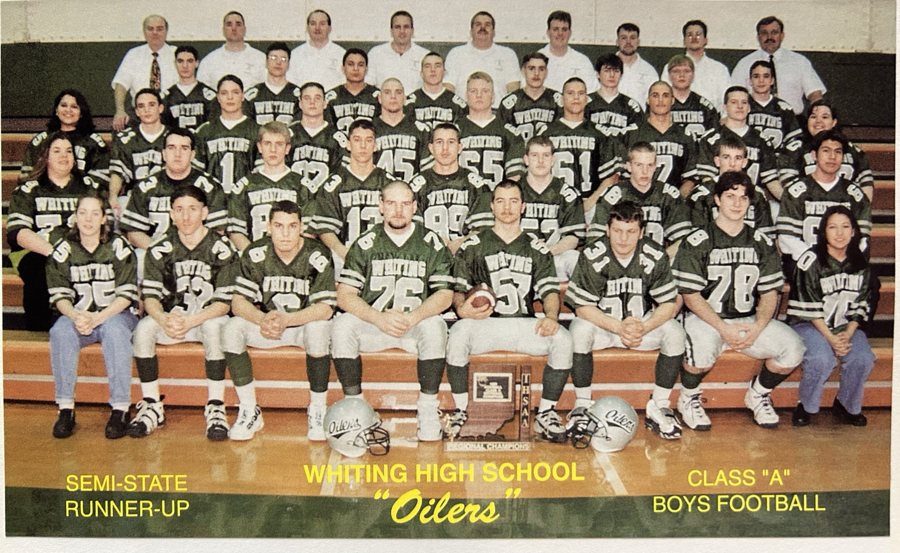 The 1996 Whiting Oilers football team poses in green uniforms around the regional championship plaque.