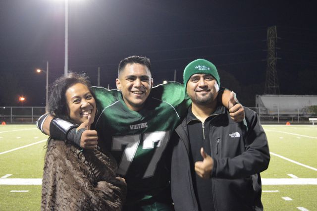 A Whiting player poses with two supporters.