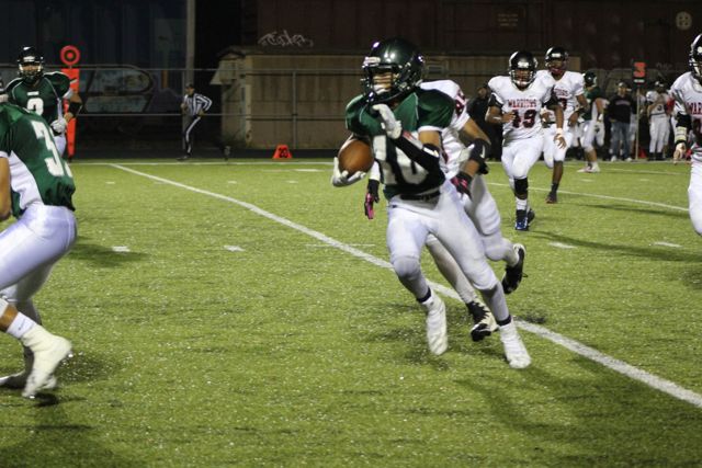 A Whiting ball carrier breaks toward the sideline.