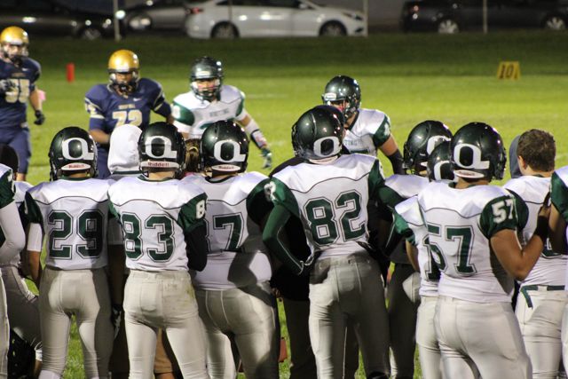 Whiting players watch the field from the sideline.