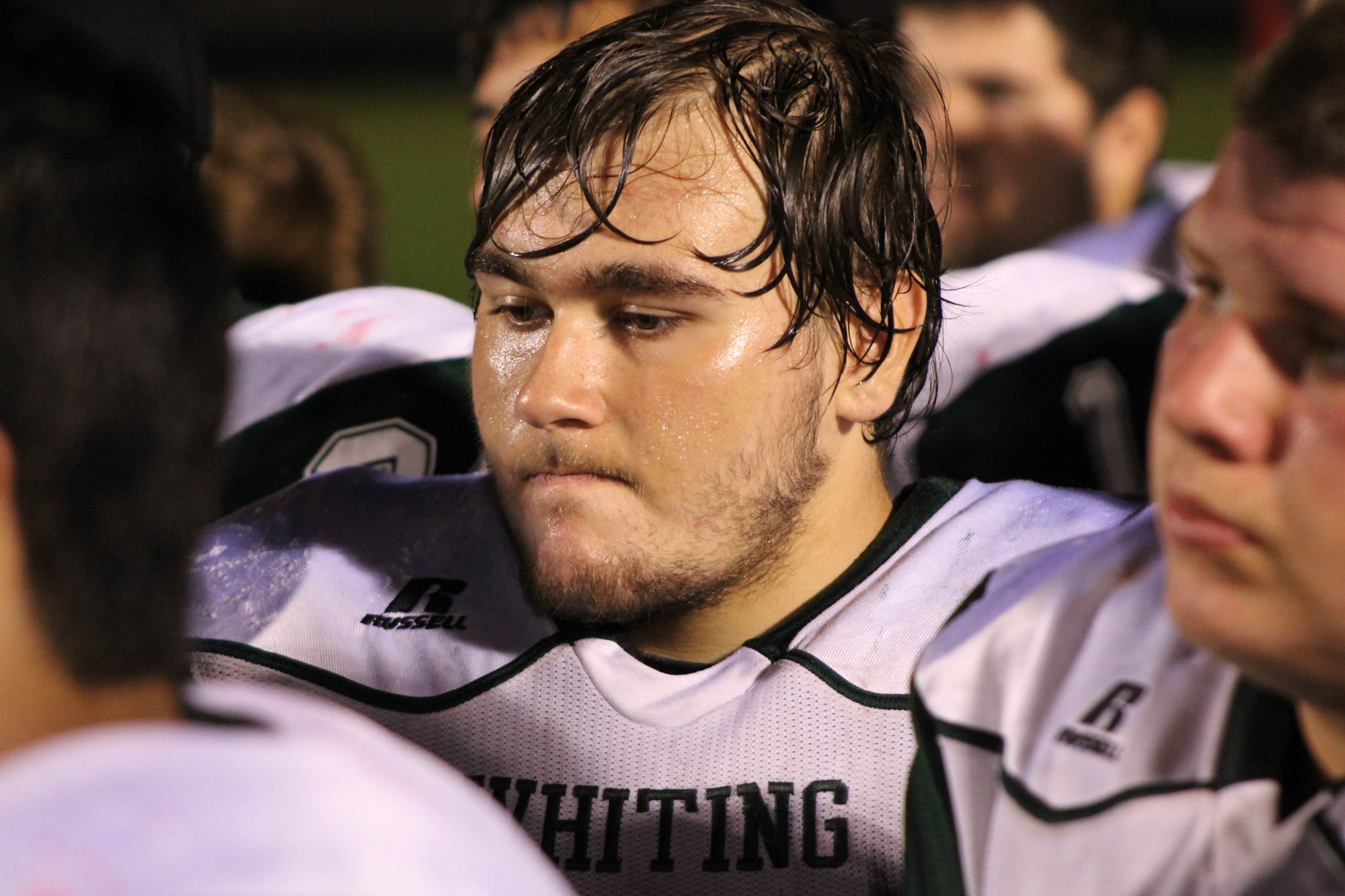 A close portrait of a Whiting player listening after the game.