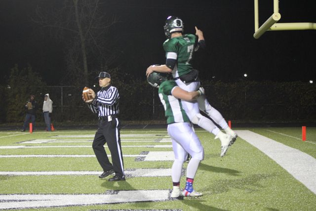 Two Whiting teammates celebrate together on the field.