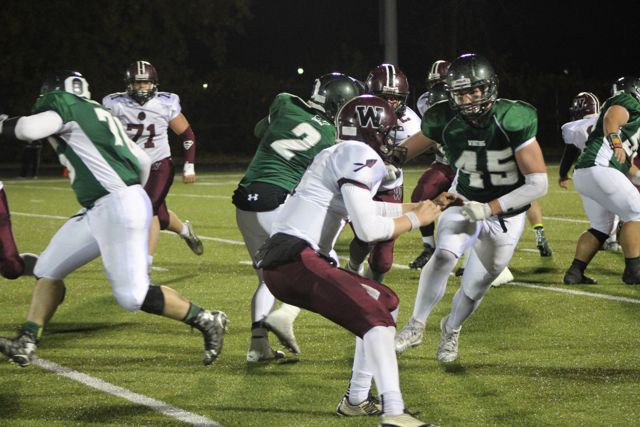 Whiting blockers engage maroon-and-white defenders.