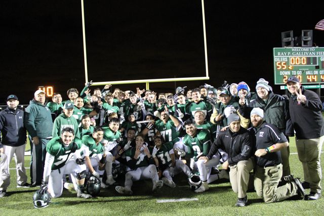 The 2016 Whiting Oilers celebrate together on the field after winning the regional championship.