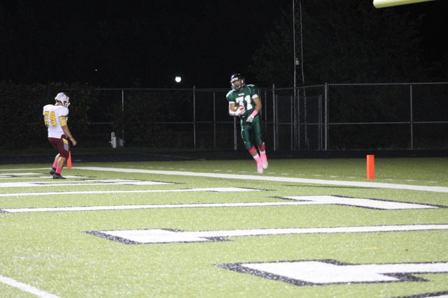 A Whiting player leaps near the end zone.