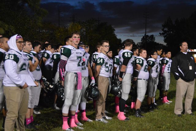 Whiting players stand together in white jerseys before a game.